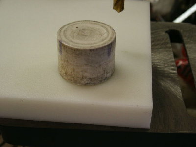 Old piston on a sheet of HDPE.  It is easy to see the diameter of the valve seat in relation to the OD of the piston.