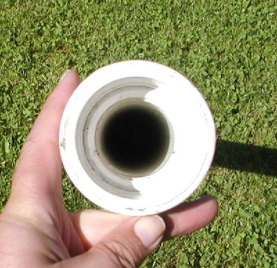 A view into the muzzle reveals the golfball barrel inside.  From the inside out is the 1.5 inch GB barrel, a 2 - 1.5 inch reducer, a 2 inch coupler, and the chamber is 2.5 inch thinwall PVC pipe.