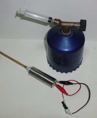 fuelling and firing setup, with blowlamp butane/propane fuel source, syringe meter and cigarette lighter piezo ignition.