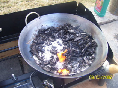 Fire on top means that most of the lead has liquified and you can start scraping off the impurities.<br />Note the bottle of fertilizer... I planted roses for my wife while I waited for the smelting process. This way, I got to do it and she didn't complain once!
