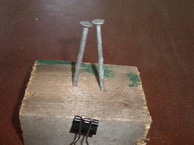 Put them together like this, leaving a small spark gap between the nails. You clip the bottom of your balloon into the document clip.