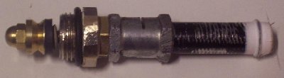 The bulky bit is where the reg threads into the chamber, from the inside ( wrong way insertion), the skinny bit holds the counterpiston and spring.