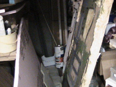 corner full of wood and paint. (the large thing on its side is an old train layout)