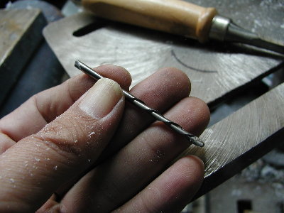 To cut the gland a small cutting tool is needed.  I simply made one using an old drill bit.  I cut an edge with a small grinding wheel.  Look at the left end of the drill bit.