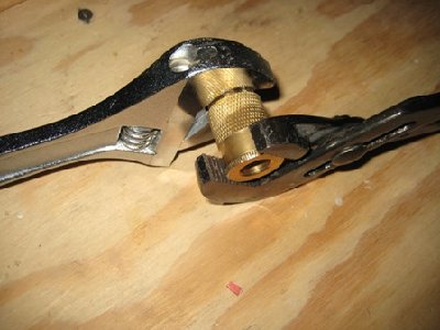 Now put the channel locks on the bumpy front part of the quick-disconnect and hold the channel locks as hard as you can, then you can unscrew the two halfs of the quick-disconnect