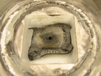 Inside the cap back side of the tire valve stem