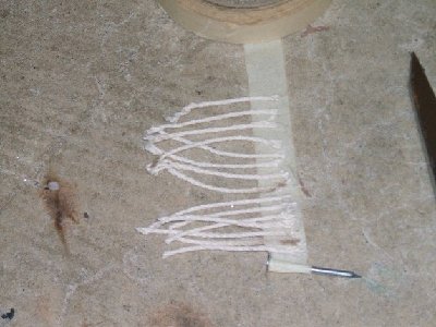Line up the string on the tape, along with the nail