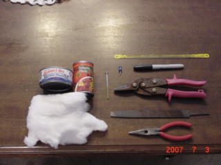 The materials needed:Tomato paste can,Tuna can,cotton balls or batting,permanent marker,thumb tack,nail,tin snips,hacksaw blade,and needle nose pliers
