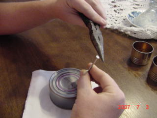 The process of punching the holes.The nail used needs to be sharpened.I used a flat Bastard file for this.The nail was then sharpened to a chisel point.