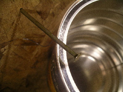 below the nail is part of a dart...it went through both sides of the coffee can and then into and peirced through particle board