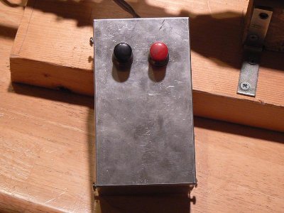 This is the control box holding the camera flash circuit. The black button charges and the red button discharges the capacitor.